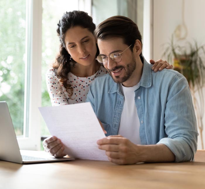 photo of a happy couple looking at a property management report