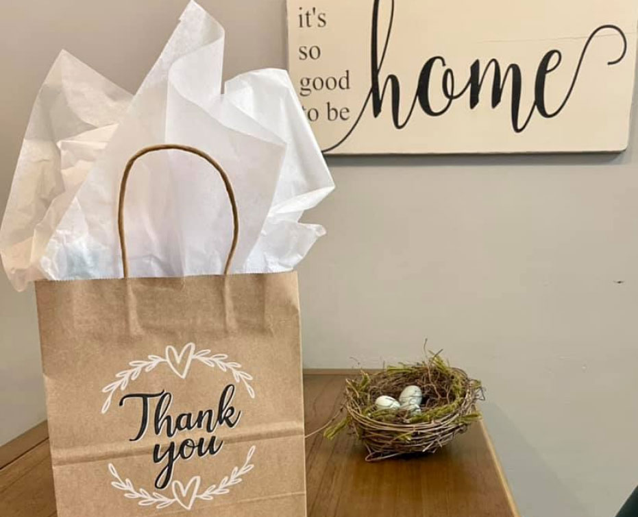 a thank you note and a gift bag for new clients